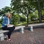 Woman journaling on benches at Santé