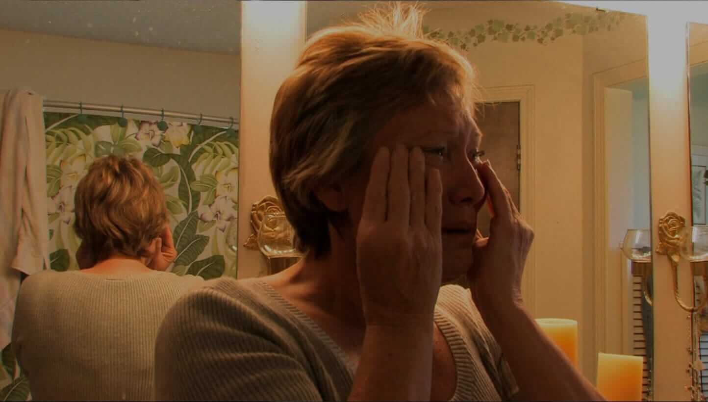 Woman crying reflected in mirror