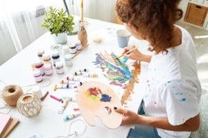A woman paints a picture as an example of creative therapy