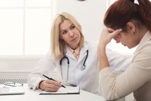 A doctor explains telemedicine options to a client
