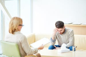 a man talks to a counselor in his ADHD treatment program