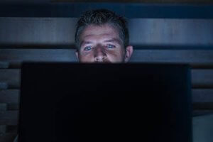 man on his laptop in need of porn addiction recovery program