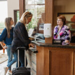Clients checking in with reception in Welcome Center.