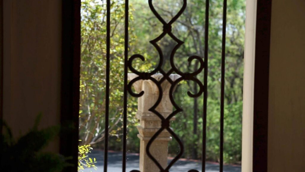 Picture of fountain at Santé Center for Healing through iron gate.
