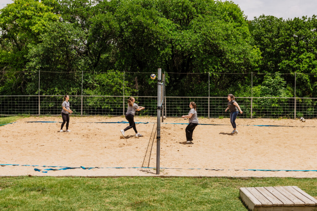 Clients playing on Volleyball court at Santé Center for Healing