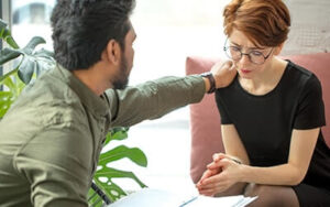 Woman is comforted by a therapist at an adderall addiction treatment center