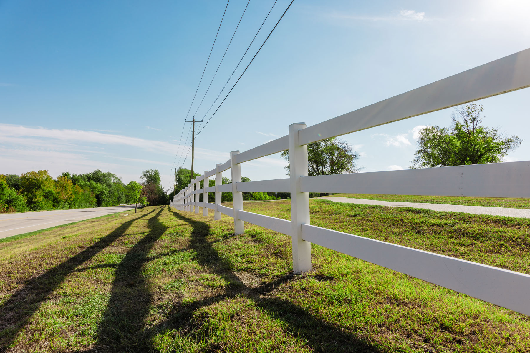 a fence by a road