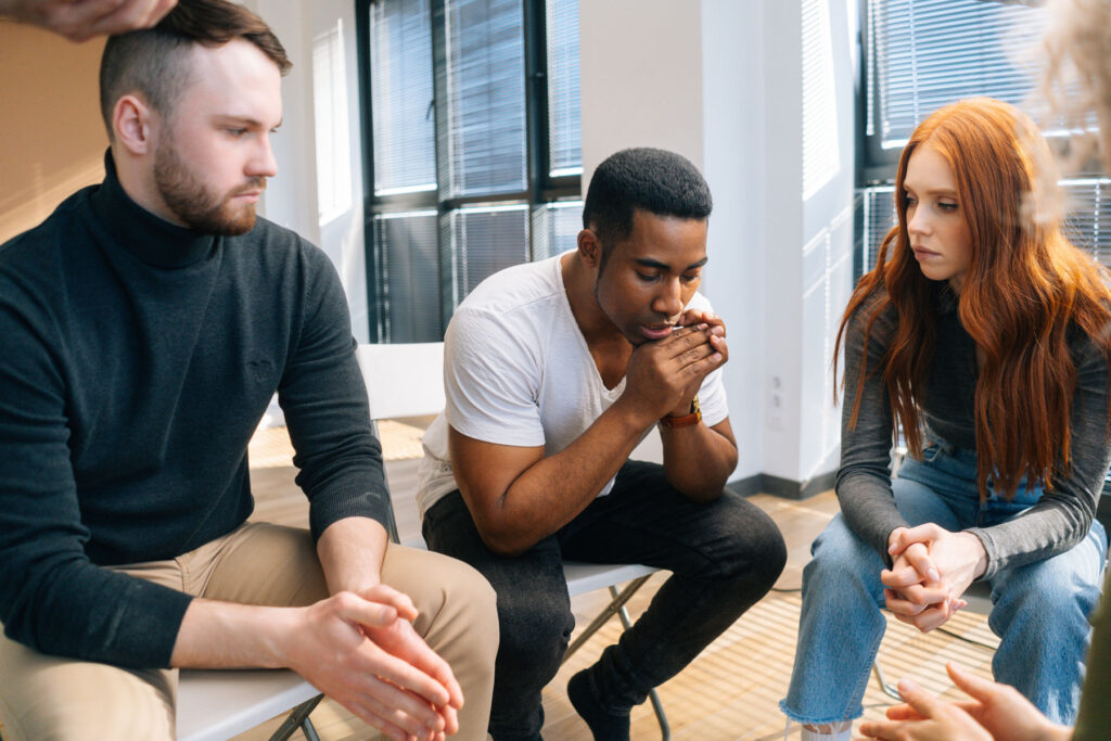 men and women participating in group therapy for depression treatment
