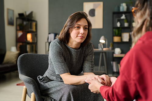 therapist in office setting speaking to woman about EMDR for addiction treatment.