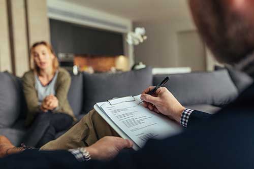 therapist talking with young woman about experiential therapy