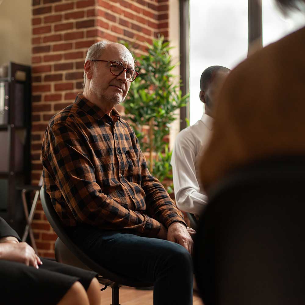 older gentleman participating in group therapy for addiction treatment