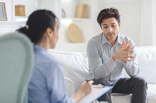 female addiction specialist discussion with young man the levels of care available for addiction treatment.