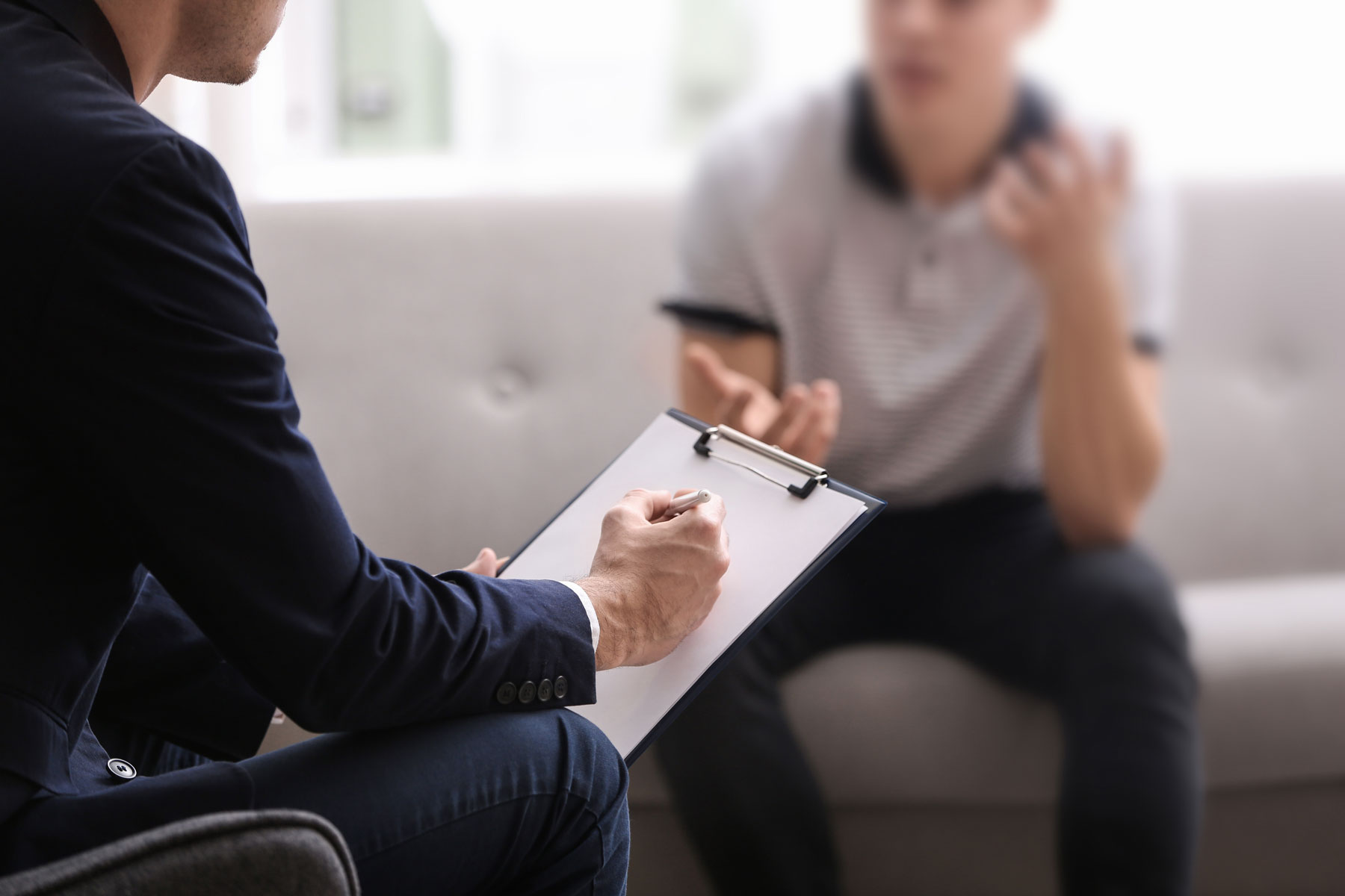 therapist meeting with client in office setting to discuss OCD treatment