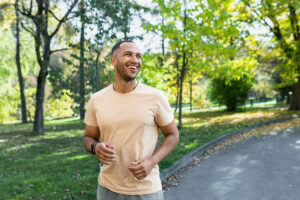 A man is out for a jog. He is smiling because he is enjoying participating in dialectical behavior therapy at Santé Center for Healing.