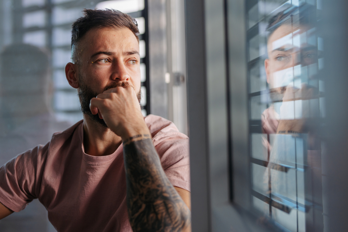 Man looking out window